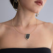 Sparkle Necklace on model: handmade brass pendant necklace worn at the neckline showing scale and proportion
