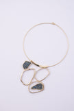 Glow Necklace front view: handmade brass geometric statement necklace with faceted crystal inset