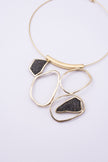 Glow Necklace close up: handmade brass necklace with tiny faceted crystals framed by sculpted brass loops