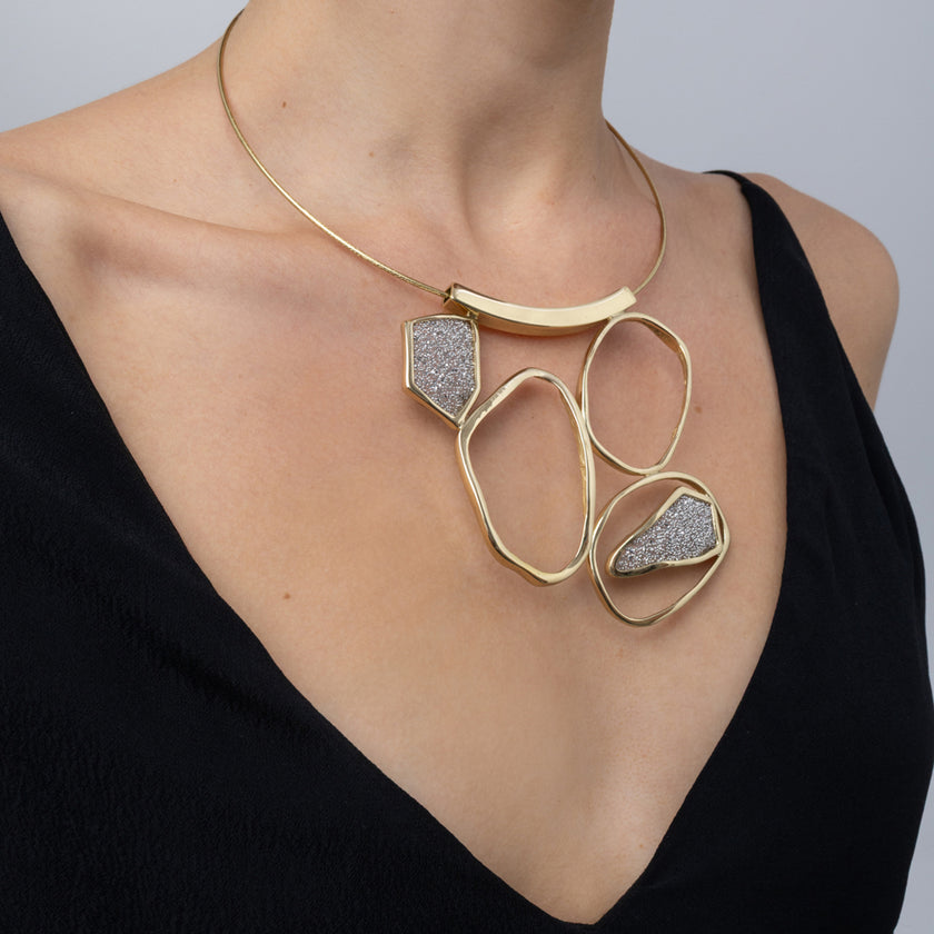 Glow Necklace on model, side view: handmade brass boho statement necklace with rigid neckwire
