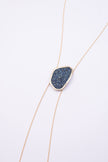 Shimmer Long Necklace front view: handmade brass geometric statement necklace with faceted crystal surface