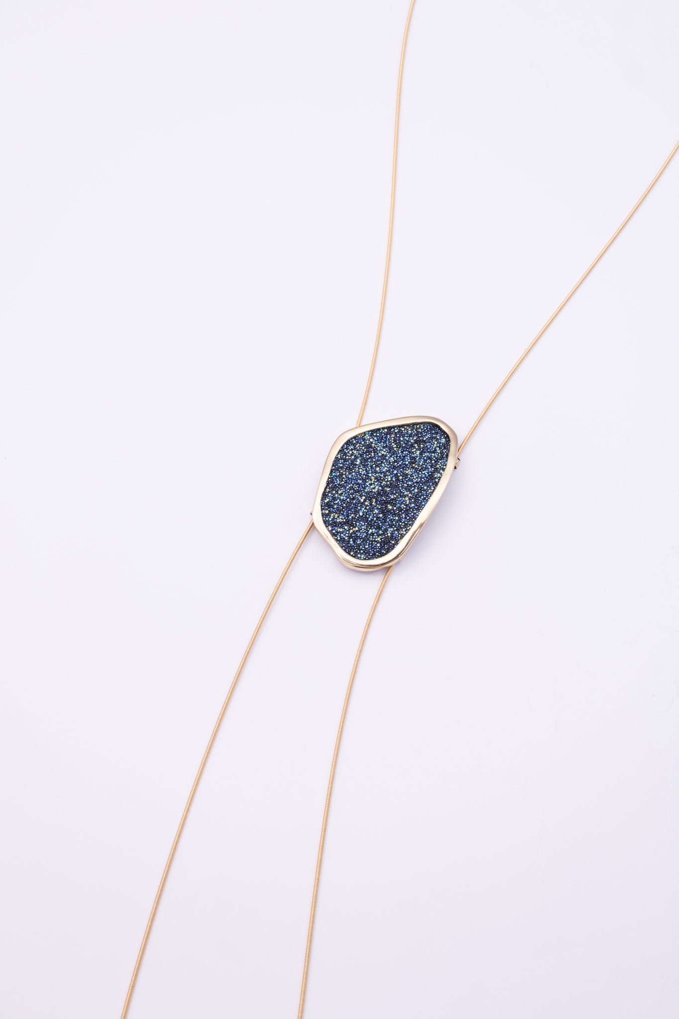 Shimmer Long Necklace front view: handmade brass geometric statement necklace with faceted crystal surface