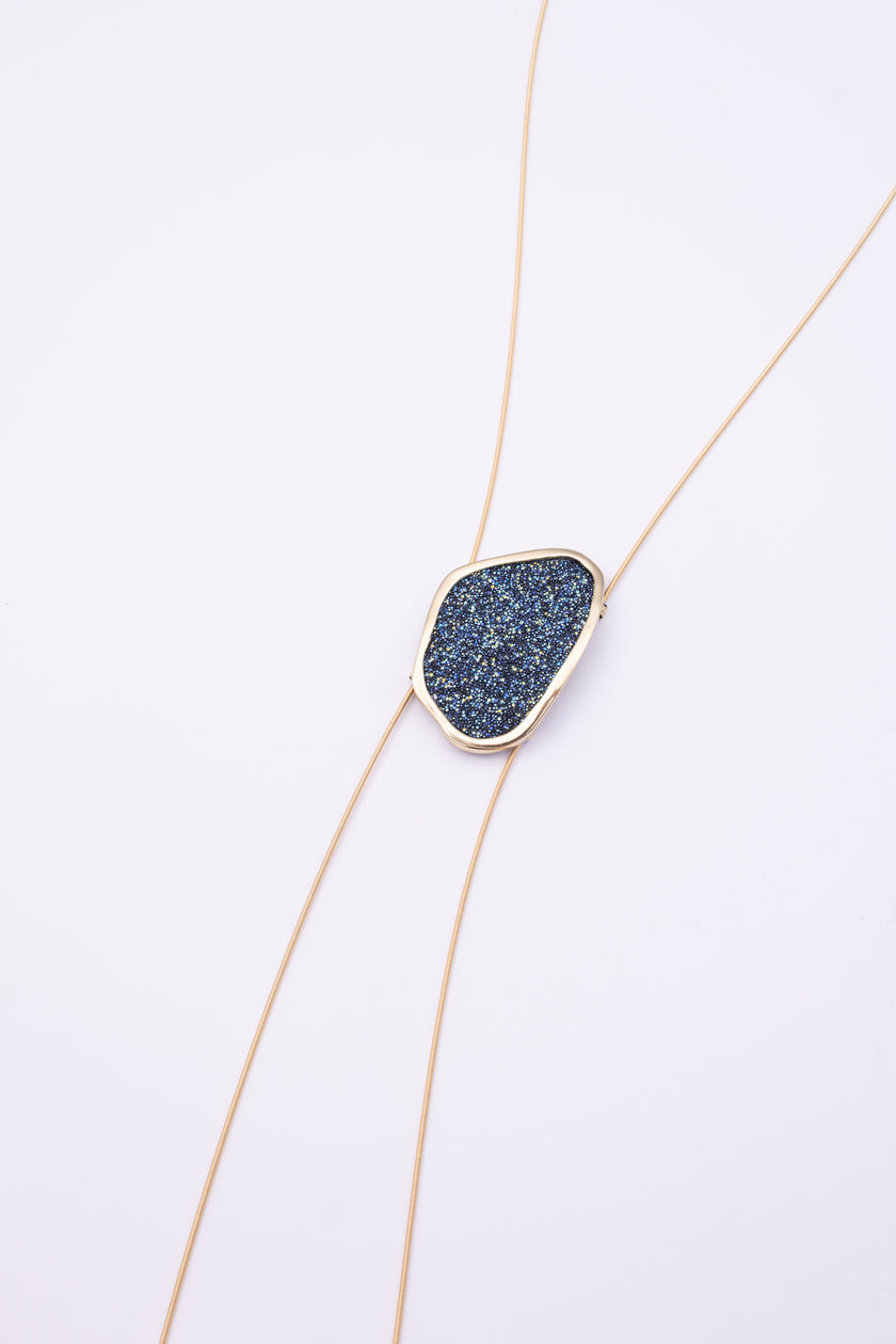 Shimmer Long Necklace front view: handmade brass geometric statement necklace with faceted crystal surface