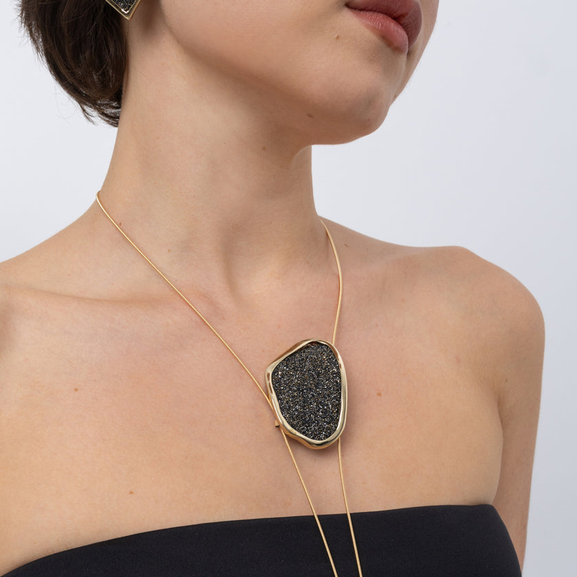 Shimmer Long Necklace on model: handmade brass sculptural long pendant necklace with sparkling crystals on slim coiled cords