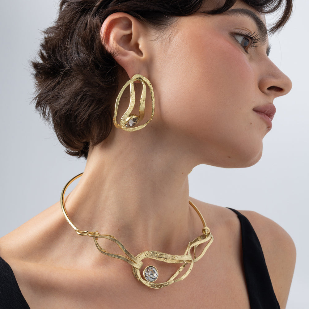 Boteh Earrings on model close up, handmade brass earrings with hammered surface and round crystal in bezel setting
