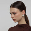 Stoneveil Earrings — handmade brass statement stud earrings with resin stone on model