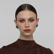 Stoneveil Earrings on model — handmade brass statement earrings worn on ear showing scale