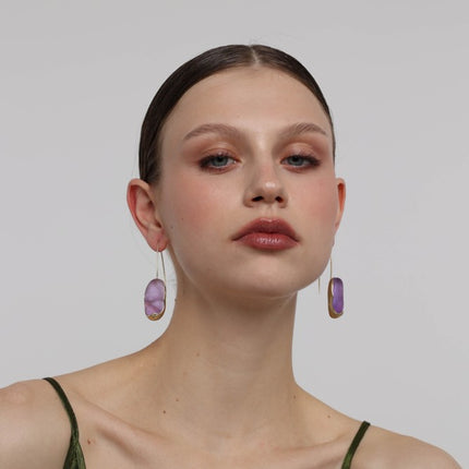 Earthpulse Earrings on model — handmade brass minimalist drop earrings with organic stone shape