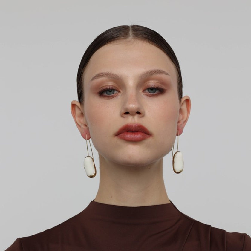 Earthpulse Earrings on model — handmade brass drop earrings worn showing scale and proportion