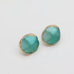 Kiss Button Earrings flat lay — handmade brass round stud earrings with resin stone accent