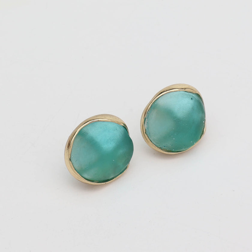 Kiss Button Earrings flat lay — handmade brass round stud earrings with resin stone accent