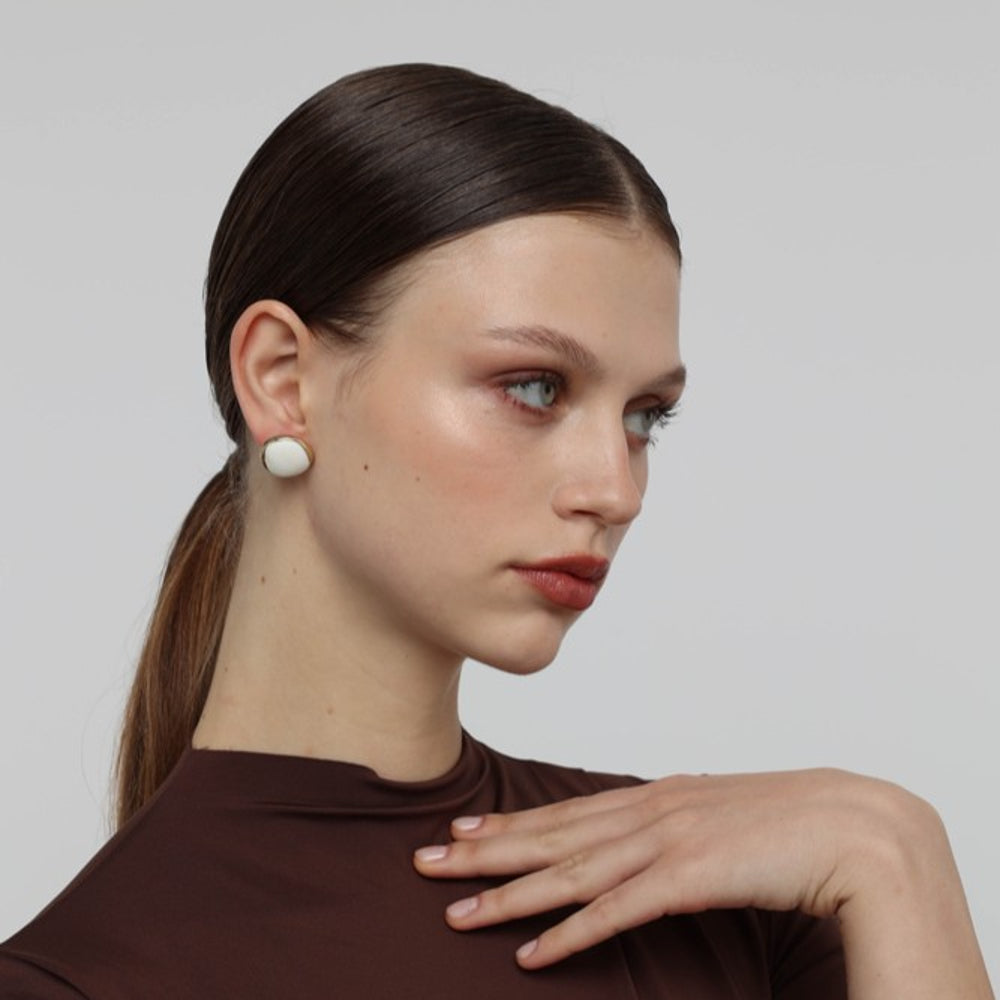 Kiss Button Earrings — handmade brass round stud earrings with resin stone on model