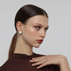 Kiss Button Earrings — handmade brass round stud earrings with resin stone on model