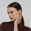 Kiss Button Earrings side view — handmade brass button earrings with organic circular silhouette