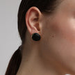 Kiss Button Earrings close up — handmade brass sculptural stud earrings with rounded stone centerpiece