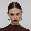 Kiss Hoop Earrings on model — handmade brass hoop earrings worn on ear showing scale and drape