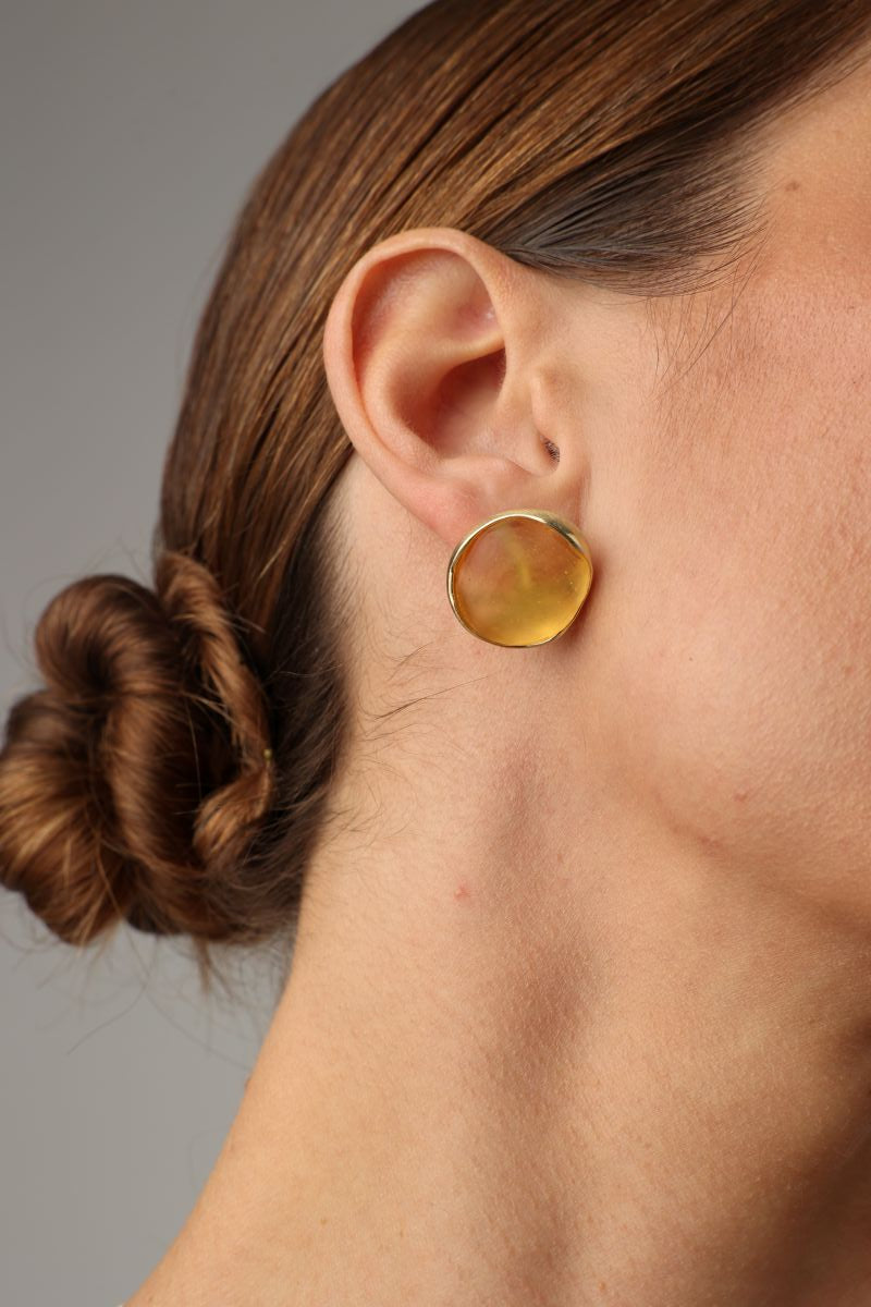 Kiss Button Earrings detail — handmade brass earring with organic edge and resin stone setting