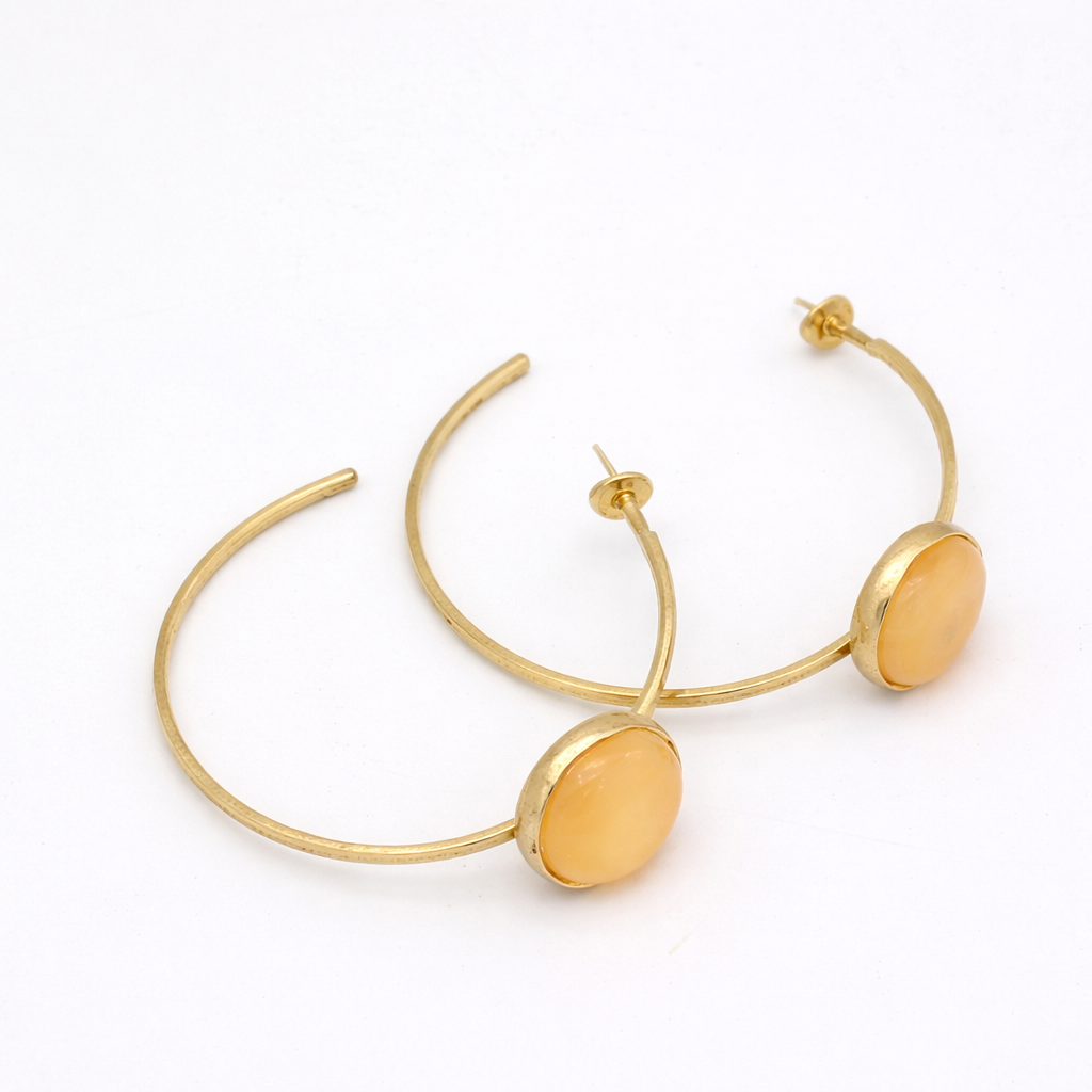 Kiss Hoop Earrings flat lay — handmade brass open hoop earrings with resin stone, pair view
