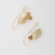 Limpet Earring — handmade brass shell pin wire drop earrings with pink crystal, flat lay