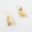 Limpet Earring — handmade brass limpet shell drop earrings with clear crystal on long pin wire, flat lay
