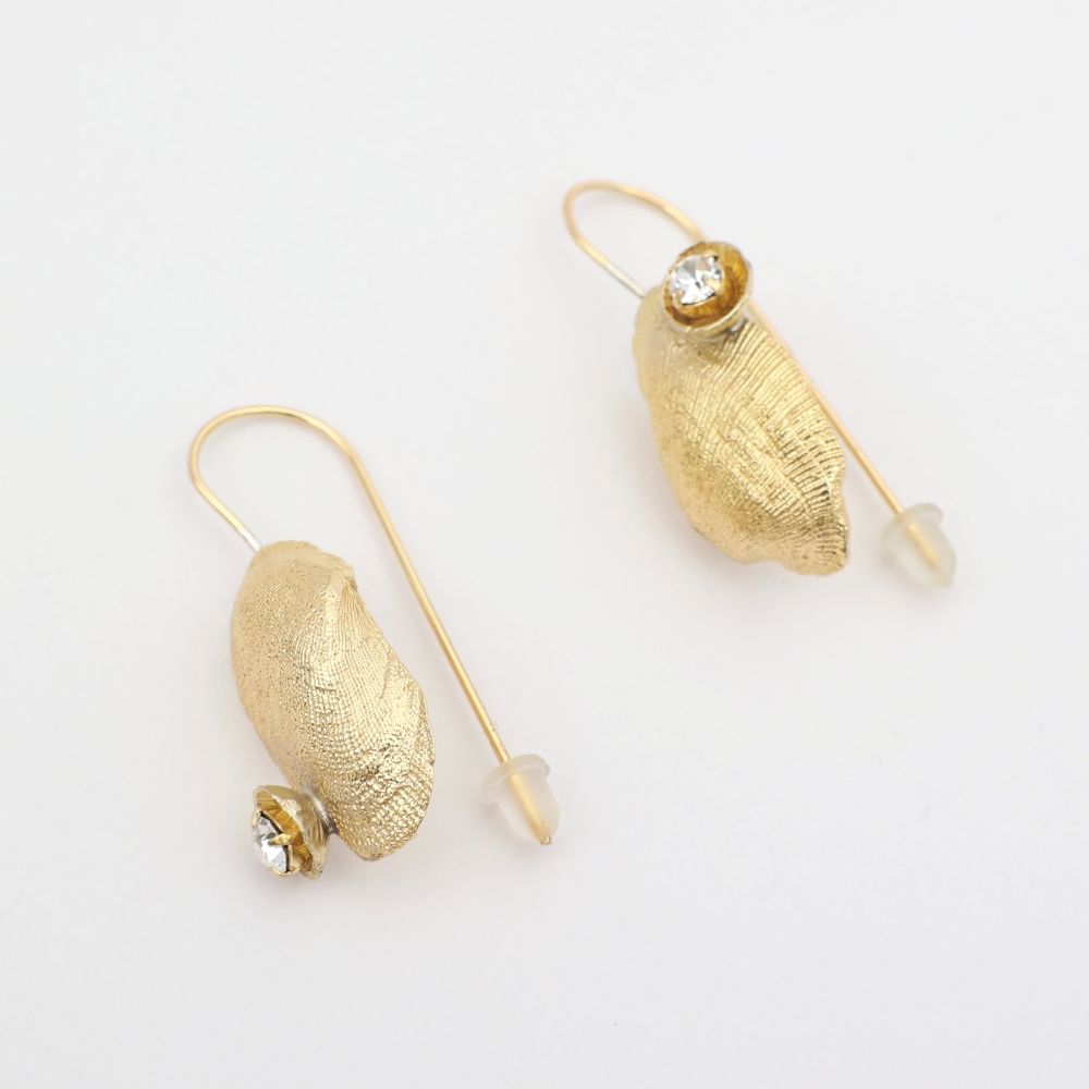 Limpet Earring — handmade brass limpet shell drop earrings with clear crystal on long pin wire, flat lay