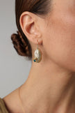  Limpet Earring — handmade brass limpet shell drop earrings with teal crystal on model, close-up