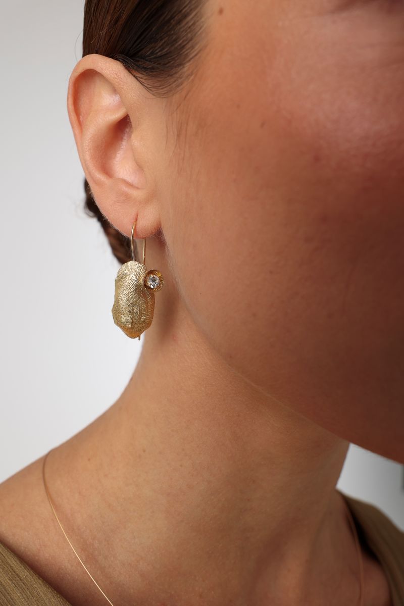 Limpet Earring — handmade brass shell drop earrings with crystal detail on model, side profile