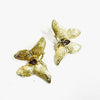  handmade brass butterfly earrings with purple crystal center stone, flat lay pair view