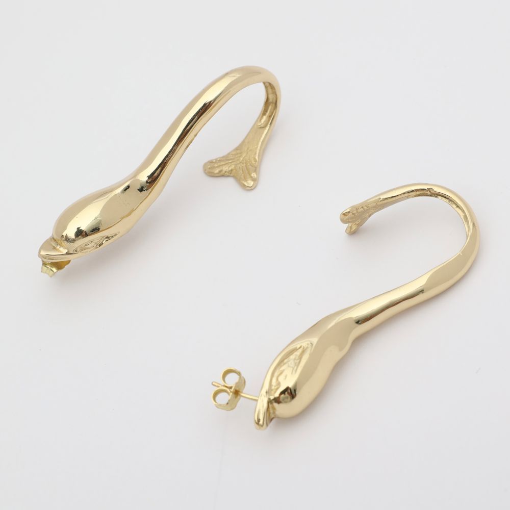  handmade brass sculptural dolphin hoop earrings, flat lay side view