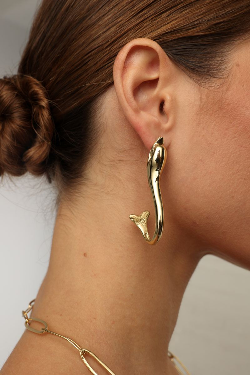 handmade brass dolphin hoop earrings on model, side profile view