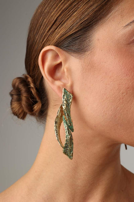 Nerra Earring — handmade brass sculptural drop earrings with twisted branch form and patina finish on model
