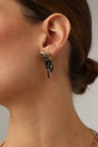 Dragonfish Earring — handmade brass sculptural stud earrings with oxidized raw texture on model