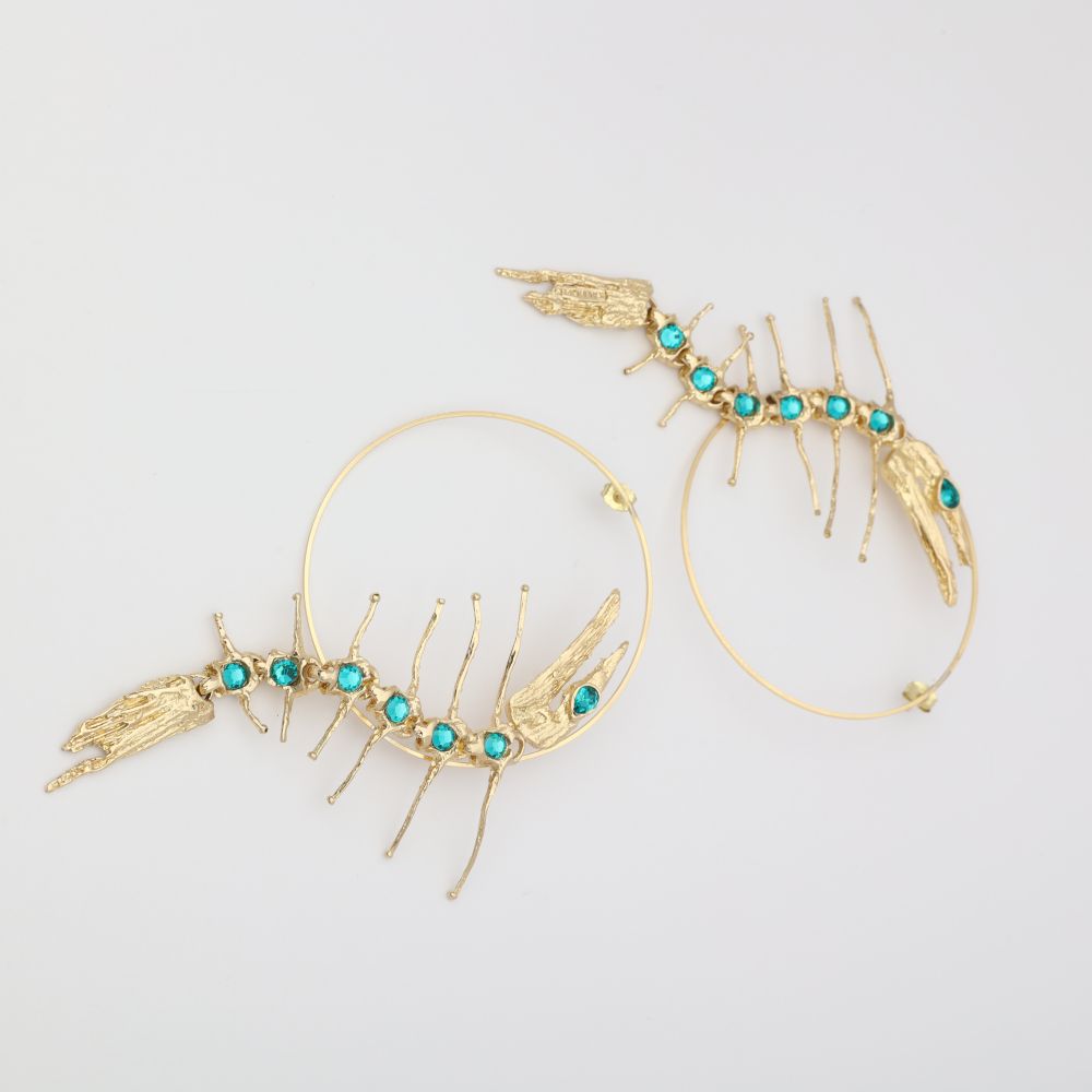 Draco Earring — handmade brass statement hoop earrings with sculptural creature and gemstone spine, flat lay