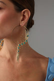 Draco Earring — handmade brass large hoop earrings with spiked creature and crystal spine on model, close-up