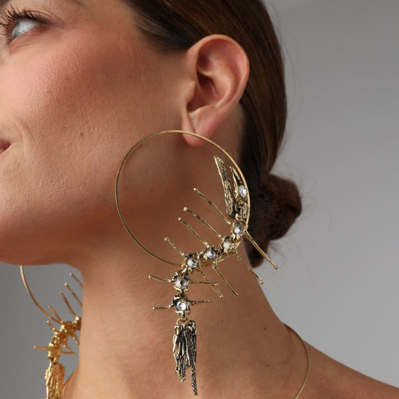 Draco Earring — handmade brass oversized sculptural hoop earrings with crystal embellishment on model, styled with necklace