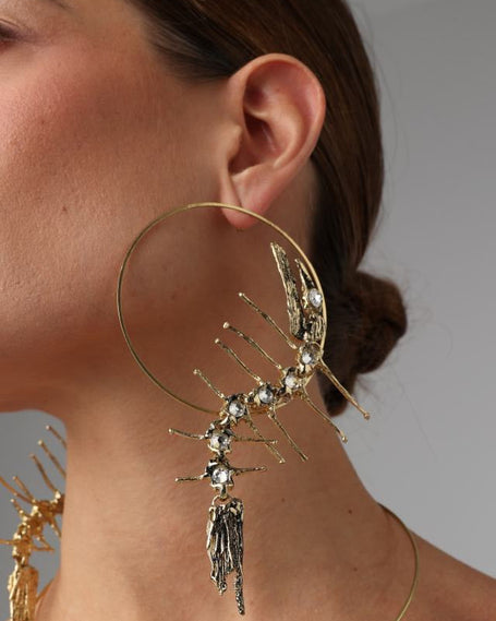 Draco Earring — handmade brass oversized sculptural hoop earrings with crystal embellishment on model, styled with necklace