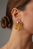 Crabby Earring — handmade brass crab earrings with amber stone body on model, bold statement artisan jewelry