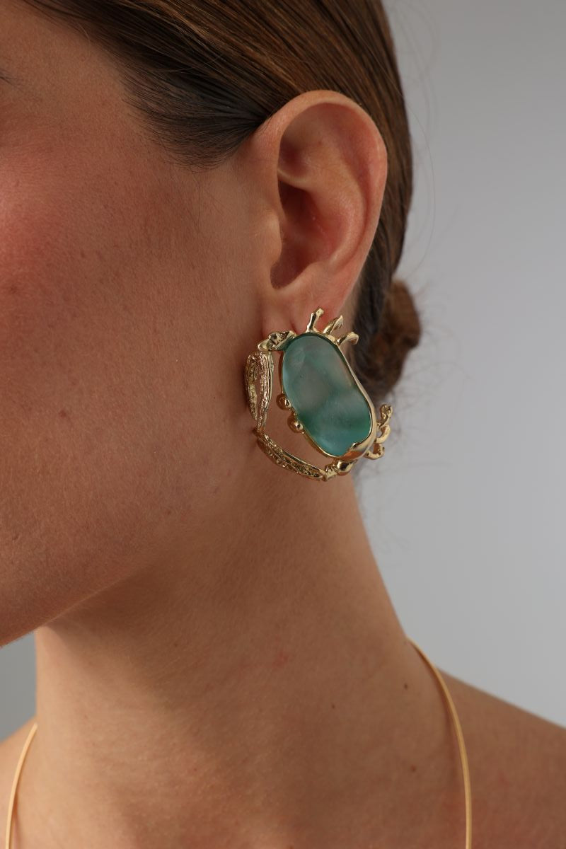 Crabby Earring — handmade brass crab stud earrings with sea glass stone body on model