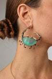 Claw Crabby Earring — handmade brass large crab earrings with sea glass stone body on model, bold artisan jewelry made in Greece