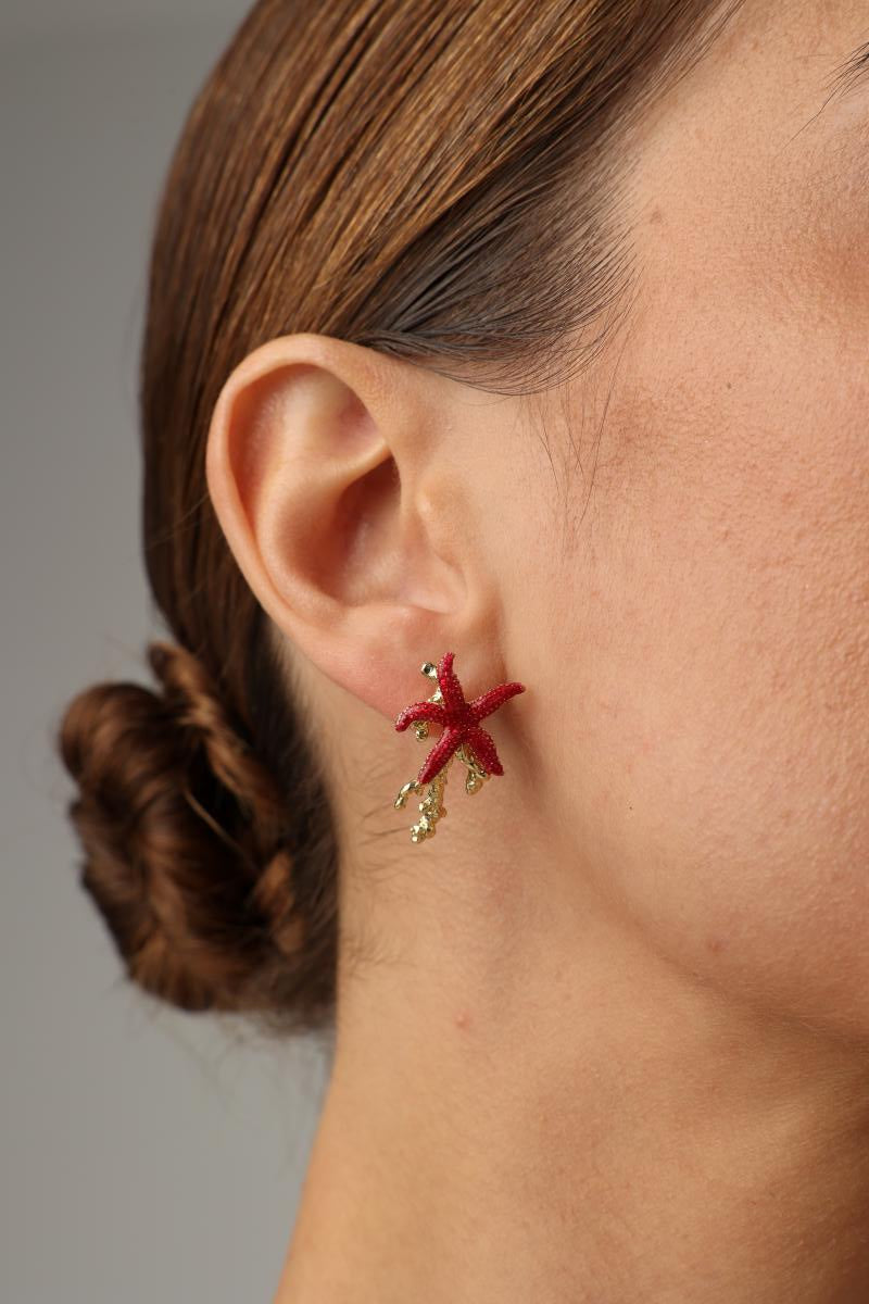 Astel Earring — handmade brass starfish stud earrings with enamel finish and coral branch detail on model