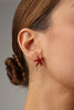 Astel Earring — handmade brass starfish stud earrings with enamel finish and coral branch detail on model
