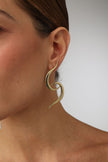 handmade brass sculptural wave earrings on model, side profile view