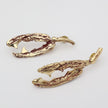 Gold antler-shaped earrings on a light gray background