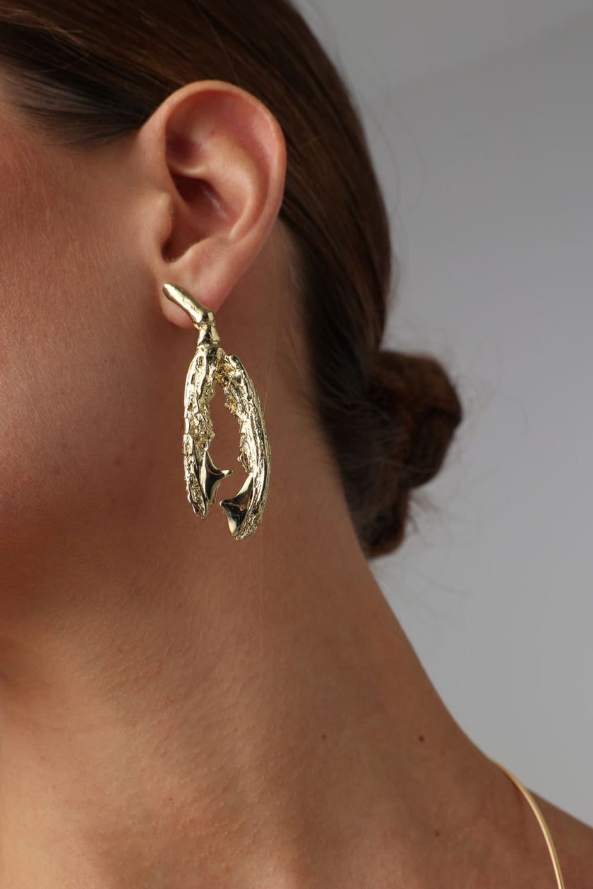 Claw Earring — handmade brass sculptural drop earrings on model, polished finish