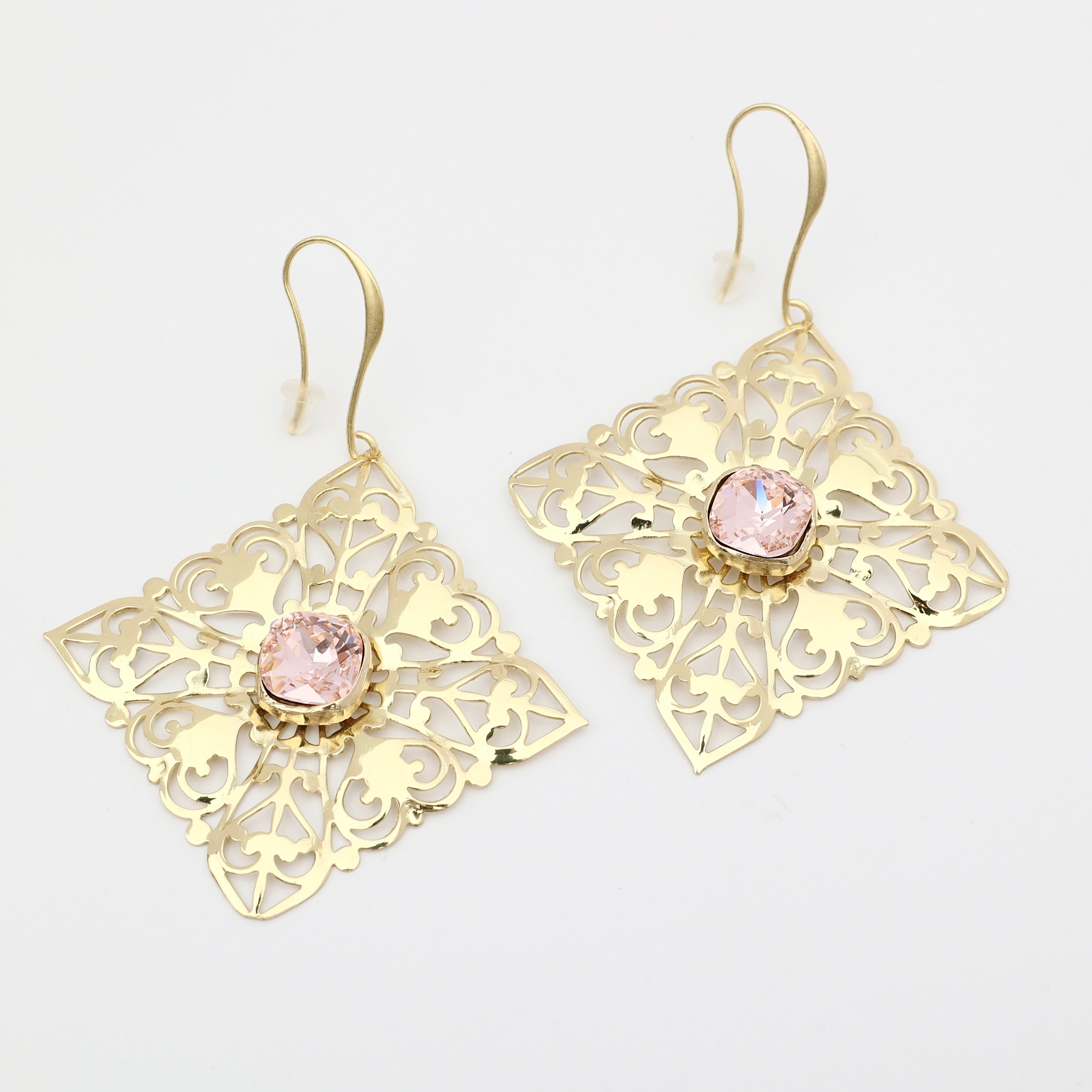 delicate gold lace earrings with pink stone studio shot