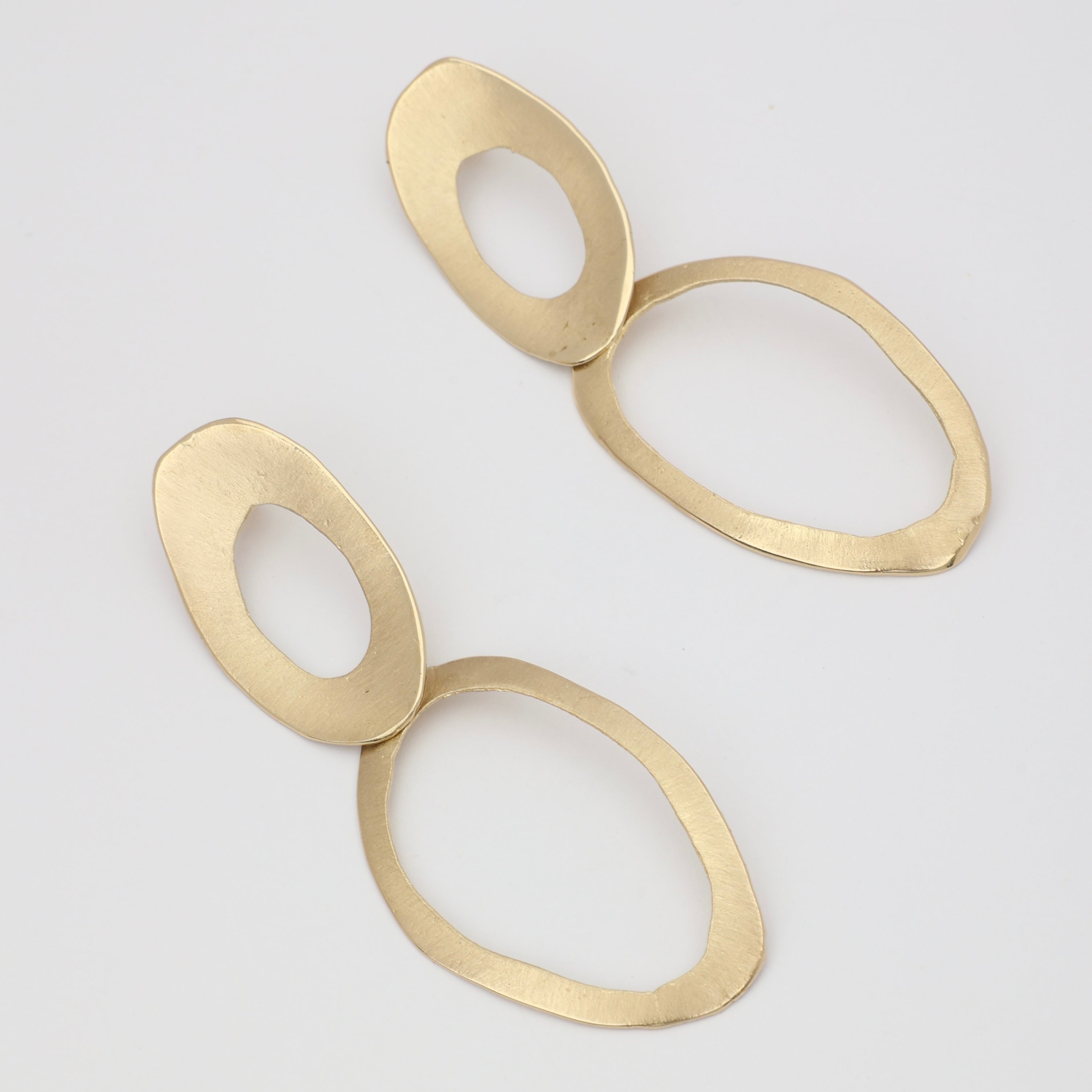 interlocking oval gold earrings studio shot