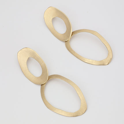 interlocking oval gold earrings studio shot