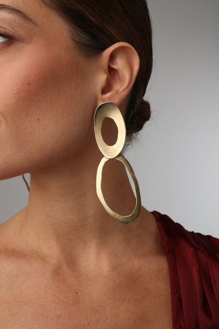 geometric handmade gold-plated drop earrings on model