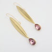 handmade gold leaf earrings with pink teardrop stone studio shot