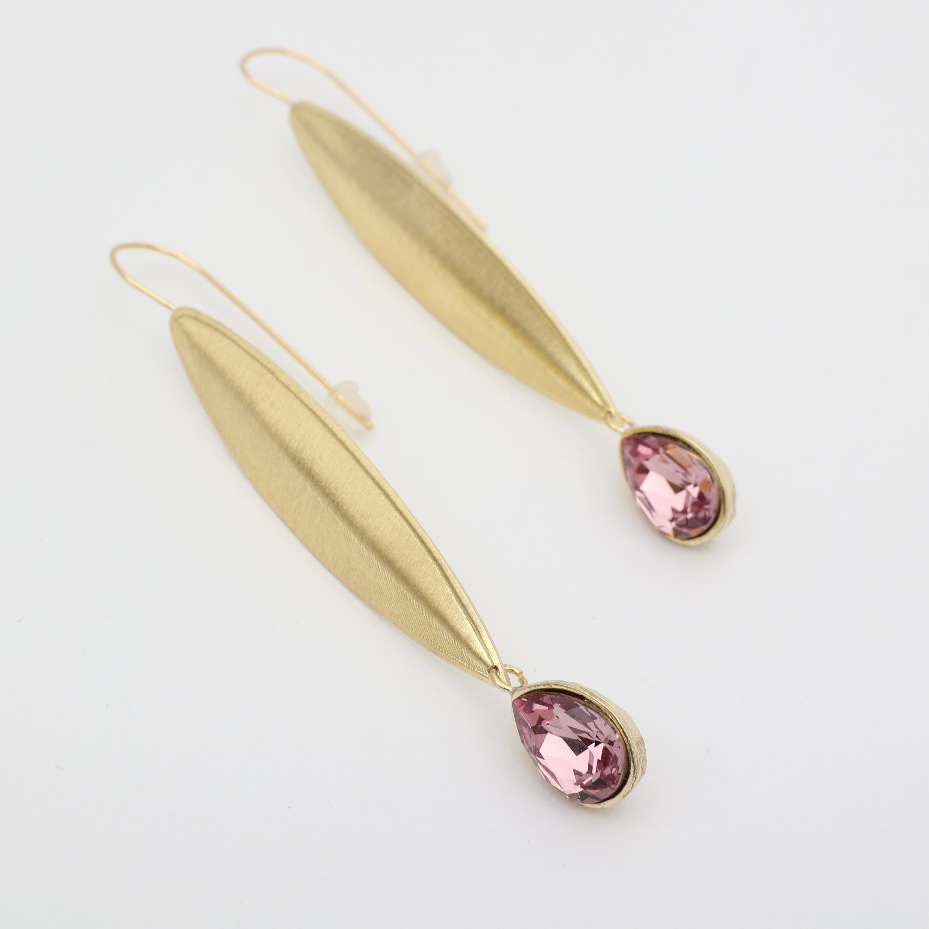 handmade gold leaf earrings with pink teardrop stone studio shot